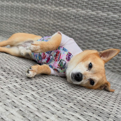 Chi mix wearing a hippie van cooling t-dog shirt outfit lying on a textured surface